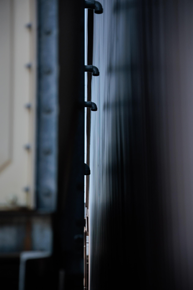 Close-up of metal surfaces depicting a narrow gap between two buildings.