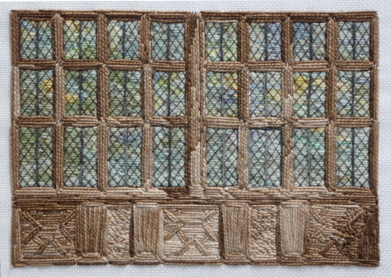 Stitched artwork depicting a large stone mullioned window with leaded lights. The view through the window is green trees