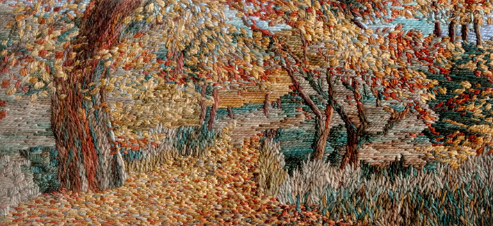 Stitched artwork depicting an autumn woodland with path