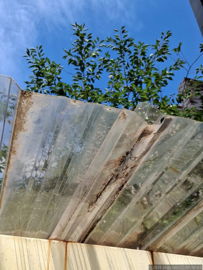 An old dirty plastic roof under sunny sunlight.