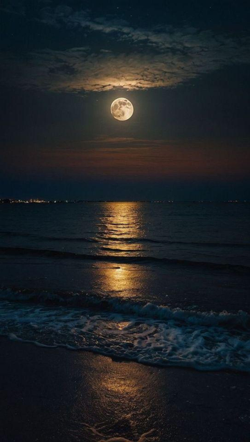 Full moon lighting up the clouds and making a path across the sea.
