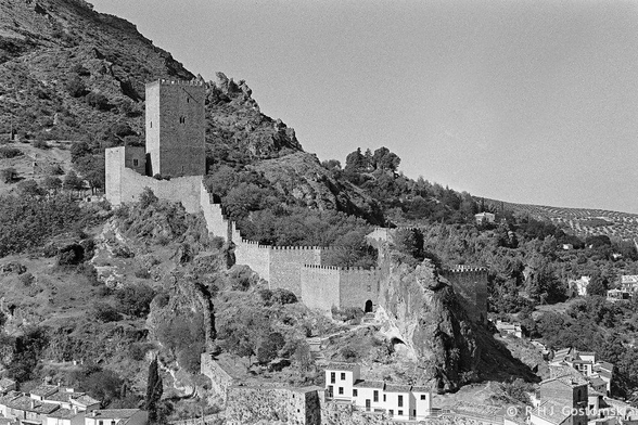 A black and white photo of Castillo de la Yedra on the hillside above Cazorla