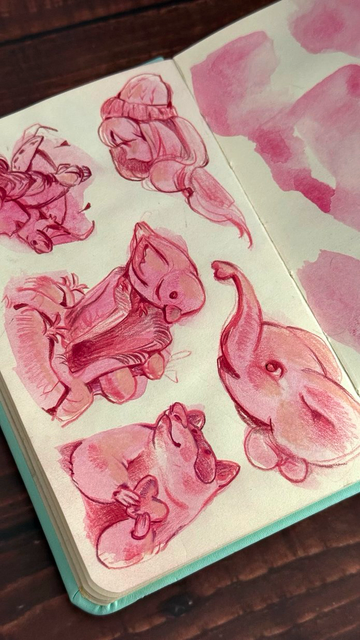 An open sketchbook with pink sketches of a bird, elephant, racoon and girl.