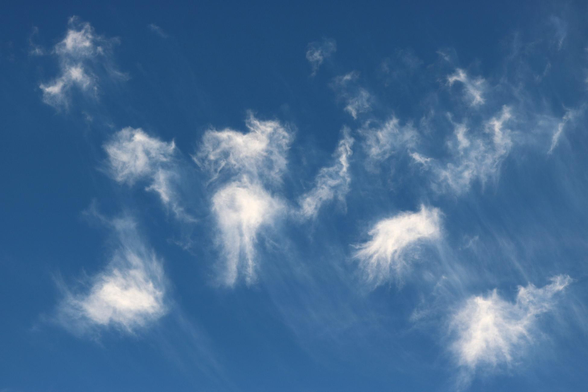 A photo of little white clouds in a blue sky