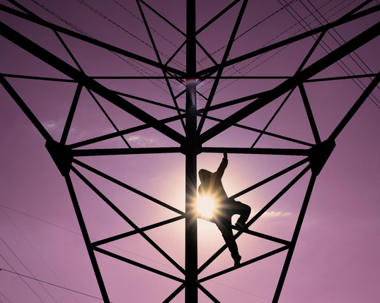 A person climbing some metal