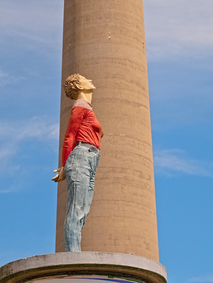 I introduced you to this column saint the day before yesterday. This time in close-up. A person stands very straight, arms crossed behind their back, looking up. Their name is Marlies. Behind them is the television tower.