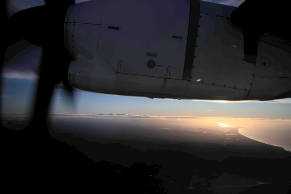 View of the coast  on the flight from Auckland to Whakatane from the air. At the top, there is the engine of an Air Chathams ATR72.
