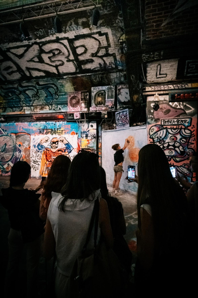 A collective of individuals is expressing appreciation for the graffiti artist's work.