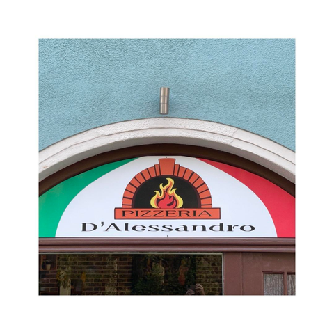 a detail of an arched window of an italian restaurant. the upper part of the square frame is showing a part of the wall painted in light blue while the arch in the lower half is showing some signage with the colors of the italian flag green, white and red