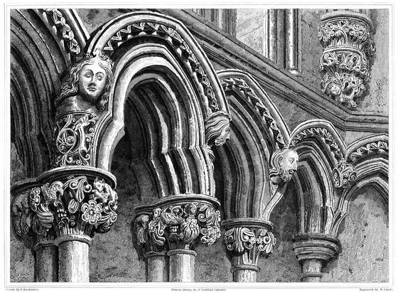 View of the arches in the chapter house of Lichfield Cathedral, showing capitals adorned with human faces and vegetal designs.