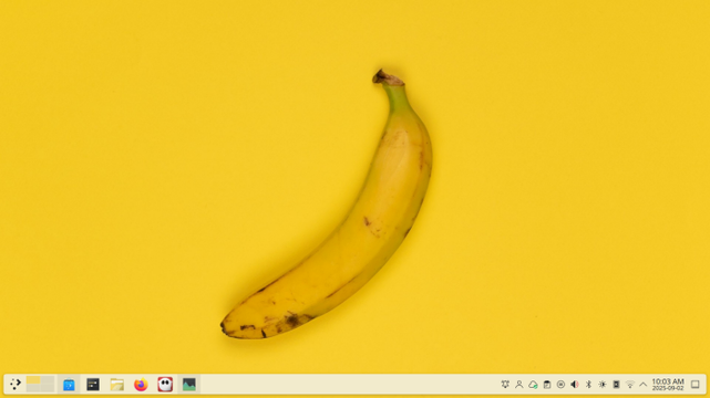 Imagen de un plátano amarillo sobre un fondo amarillo como fondo de escritorio de un sistema GNU/Linux con una barra de aplicaciones en la parte inferior
