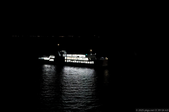 A ferry boat in night sea, entering the port. Kagoshima, Japan.