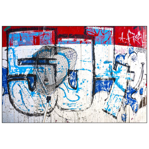 This image shows a section of a wall of a lighthouse covered in colorful graffiti. The artwork features a mix of blue, red, and white paint, with bold outlines and abstract shapes. In the center, there is a fishing net. The wall appears weathered, with some areas showing signs of wear and tear. (draft by mistral, edited by author)
