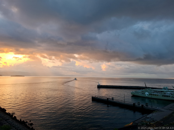 A ferry left the port, into the sunset sea.
