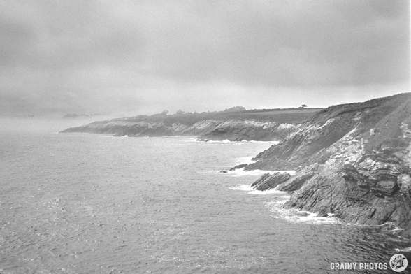 A black-and-white film photo of a misty coastline, Ribadeo, Galicia