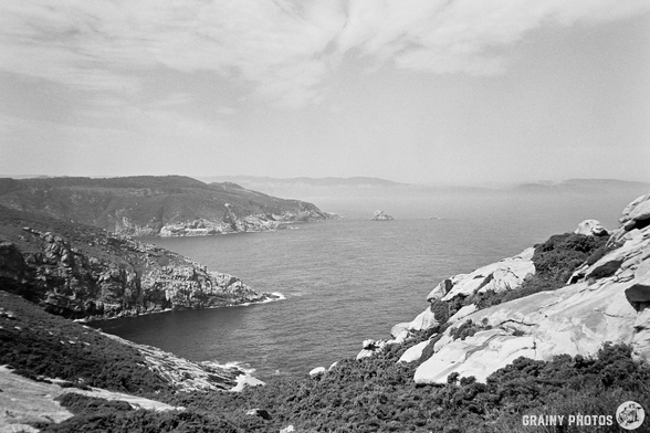 A black-and-white film photo of a misty Roncadoira coastline
