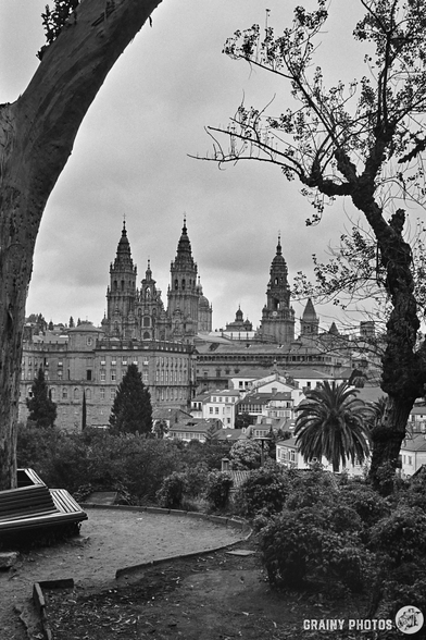A black-and-white film photo of the cathedral in Santiago de Compostela⁩ viewed from the park
