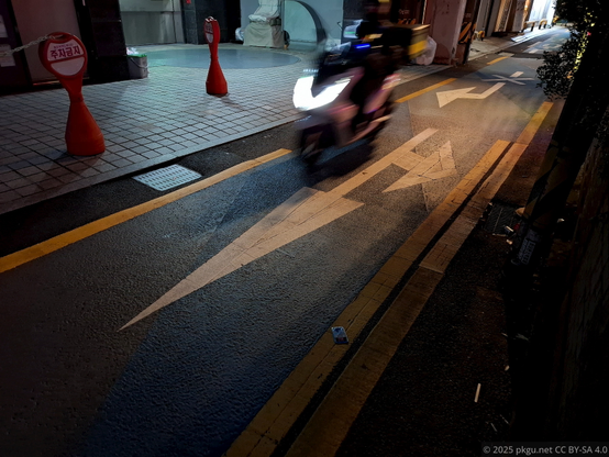A delivery rider on the back street. Seoul, Korea.
