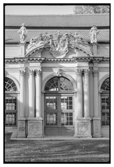Black and white photograph in porttrait orientation. The ornate entrance to a building.