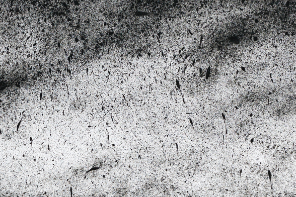 Black and white ink drawing depicting a volcanic landscape where the rocks appear both artificial and natural at the same time.