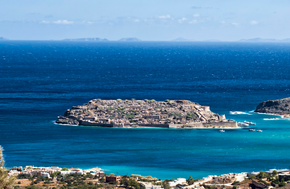 An Island in a bay that is covered with old buildings