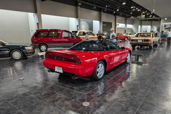 A red honda nsx sports car surrounded by other displayed cars