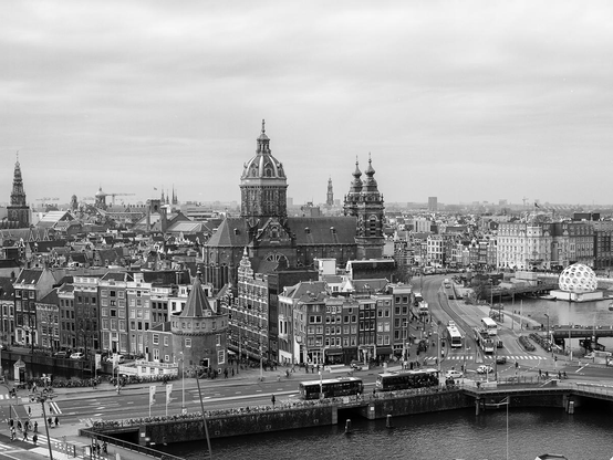 Historic buildings in the center of Amsterdam in black and white. The country's largest city is visited by over 10 million foreign tourists a year.