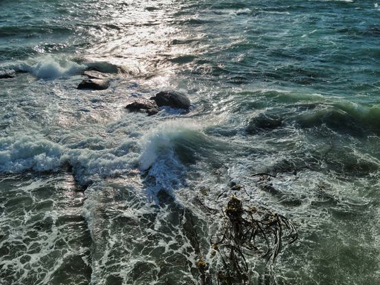 This is an image of the waves along the Dallas Road walkway in Victoria, BC breaking over the shoreline rocks during a eindstorm.