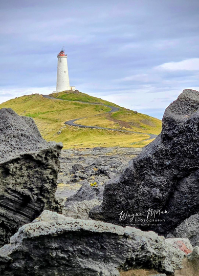 Reykjanes Lighthouse – Beacon on the Edge of Iceland

Description:
Perched atop a windswept hill of volcanic rock and golden moss, Reykjanes Lighthouse (Reykjanesviti) stands as a steadfast guardian overlooking Iceland’s rugged southwestern coast. Its white tower and crimson crown rise in striking contrast against the dark lava fields below, a symbol of safety and resilience in one of the country’s most dramatic landscapes.

This historic lighthouse, first built in 1878 and later reconstructed after an earthquake in 1905, marks Iceland’s oldest operational beacon. It watches over the Reykjanes Peninsula, a region where the Mid-Atlantic Ridge surfaces from the ocean — a living rift where the North American and Eurasian tectonic plates slowly drift apart.

Surrounding the lighthouse is a world shaped by elemental forces. Jagged lava flows stretch toward the sea, hardened remnants of ancient eruptions. The nearby cliffs of Valahnúkamöl plunge into the Atlantic, where powerful waves crash endlessly against basalt formations and sea stacks. 

Image:
https://fineartamerica.com/featured/reykjanes-lighthouse-beacon-on-the-edge-of-iceland-wayne-moran.html

Read more:
https://waynemoranphotography.com/blog/chasing-light-across-iceland-our-21-day-adventure/

#lighthouse #Reykjanes #Iceland #nature #travelPHotogrpahy #Landscape #landscapes #art #fineart 

#ayearforart #buyintoart
