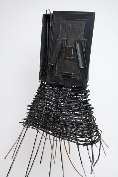 a sculptural mask inspired by African ceremonial masks, made from a colonial-era writing desk