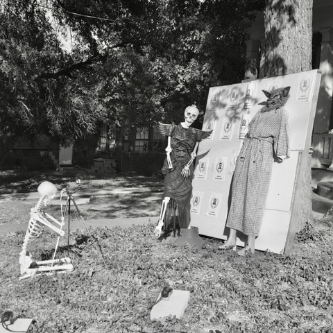 A black-and-white film photo. A skeleton photographer poses their ghoulish subjects in this wonderful tableau in Austin, Texas. Monday, October 20, 2025.