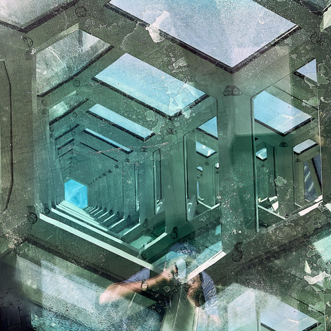 The image shows a reflective surface capturing a pattern of geometric shapes. It has multiple green-tinted, rectangular frames layered on each other, creating a tunnel-like effect. The reflection also includes the faint outline of a person holding a camera