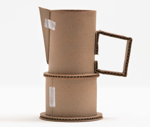 a brown ceramic vessel that appears to be made from corrugated cardboard