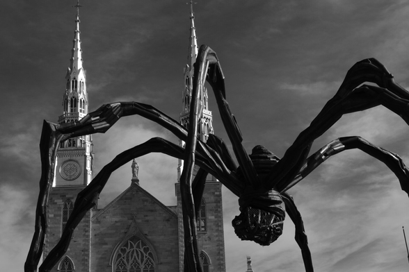 Outside the Gallery, the spider like shape of the sculpture titled Maman fills the lower right of the frame. In the upper left, in the background are the twin spires of Notre Dame Basilica