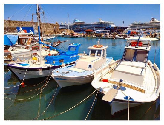 Colour photograph of small boats moored in a harbour, Rhodes, Greece.