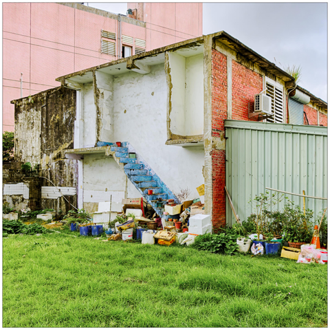 Stairs of a residential home, apparently in the process of being renovated, but with half the building missing.