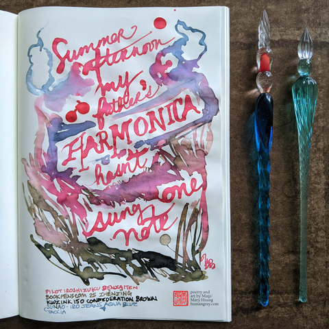 Photo of open notebook next to two glass dip pens, one slightly sanded down with a blunt tip. The page shows a haiku written in bold coral ink with scribbles of cloud and grass-like shapes in blue, pink, brown blending into each other and forming purples, mauves and taupes where they meet.
"summer afternoon
my father's harmonica
hasn't sung one note"
- Poetry and art by Maiji/Mary Huang, humangray.com