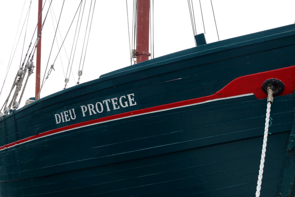 part of a sailing ship with name "god protects"