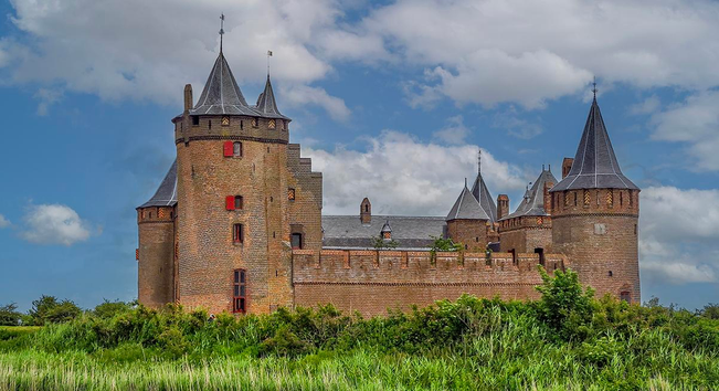Famous medieval Muiderslot castle in Holland

The Muiderslot from 1280 is a castle in Muiden, about 15 km southeast of Amsterdam, at the mouth of the river Vecht in the IJsselmeer.

The Muiderslot was built by Count Floris V  when he gained command over an area that used to be part of the Sea of Utrecht. Utrecht was one of the most important trade towns of that age.