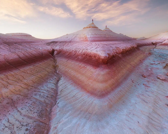 More mountain ridges from the sea floor in layers of pink, white and pale orange