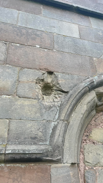 A close up picture of cannonball damage from the 1643 siege of St Bartholomews during the English Civil War.