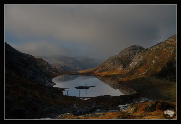 Early misty morning on the Matrefjellet, beauty mountains surround a small lake.