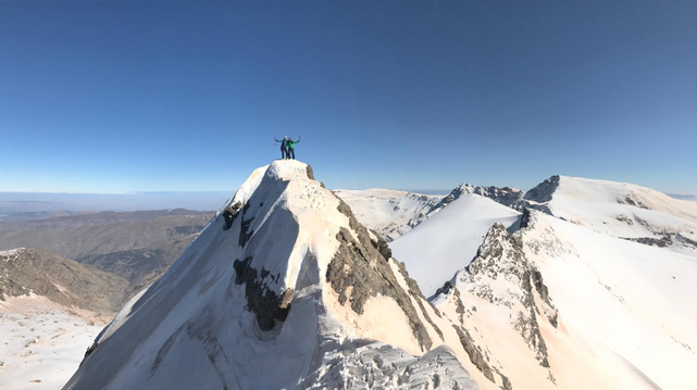 People on top of the peak Salon in Spain's Sierra Nevada in winter
