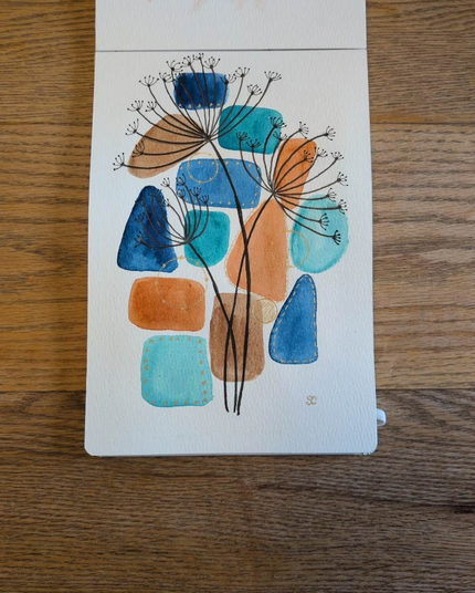 This is a mixed media watercolor painting with ink in portrait orientation in an A5 sketchbook. The background is made up of watercolor shapes in blue, aqua, orange, and brown. On top of the background are 3 stems of a multi branchlet with little dried seeds at each mini branchlet in black ink. Finally there is gold detailing around and in-between some of the watercolor shapes.