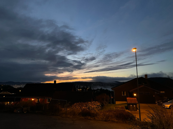 The sky is of blue and glowing colors, while the streetlights still are on this morning.