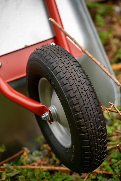 Der Focus liegt auf dem Rad einer Schubkarre. Diese ist neu und Demzufolge ist das Profil des Reifen sauber.