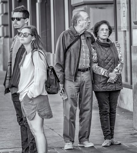 Older couple standing near younger couple on a sidewalk in San Francisco. The older woman is staring fixedly ahead as if she can't believe what she's seeing.