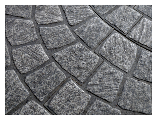 Textured cobblestones laid in a curving, fan-like pattern. The stones are separated by dark grout lines. - Google Gemini 2.5 Pro