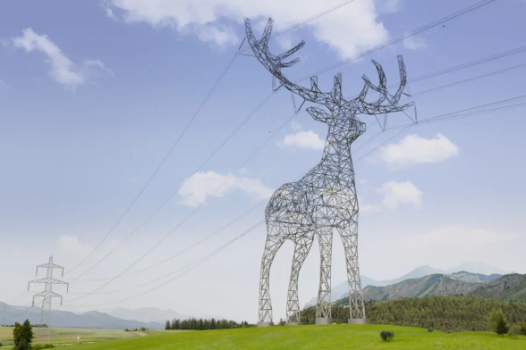 A power pylon shaped like a deer, antlers supporting the power lines. It's set in an alpine region