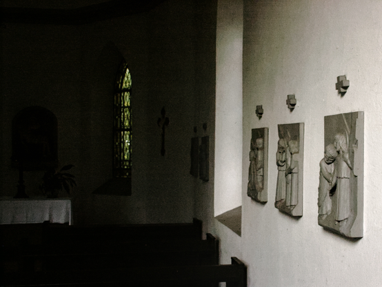 part of the stations of the cross inside a small chapel